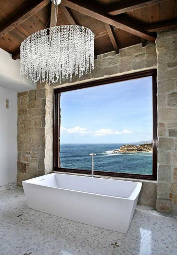 The bathroom has a beautiful view of the sea