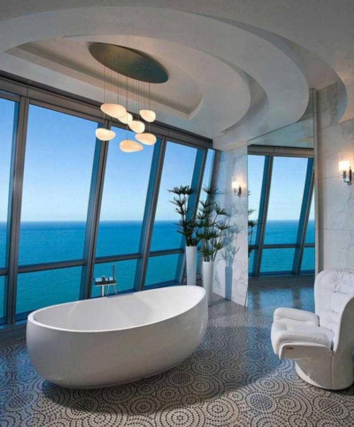 The bathroom has a beautiful view of the sea