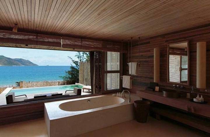 The bathroom has a beautiful view of the sea