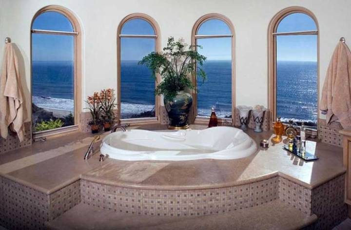 The bathroom has a beautiful view of the sea