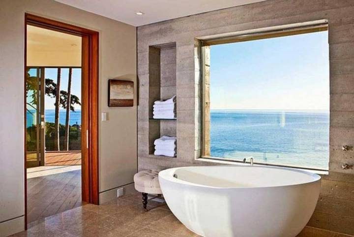 The bathroom has a beautiful view of the sea