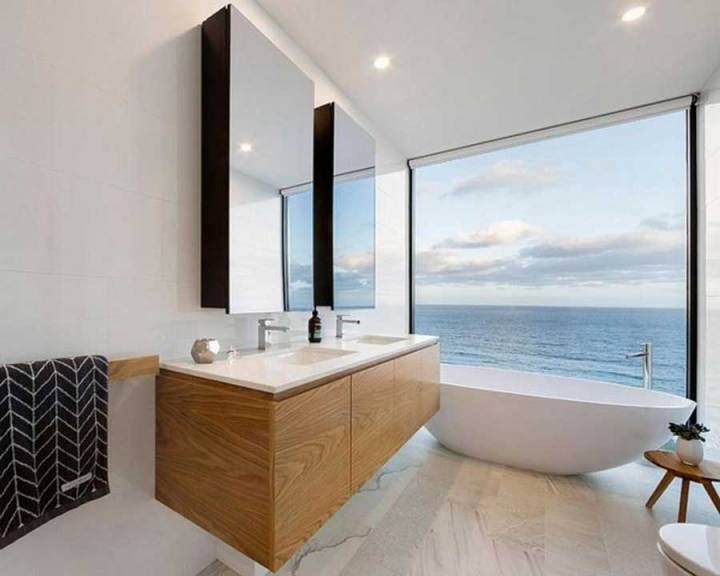 The bathroom has a beautiful view of the sea