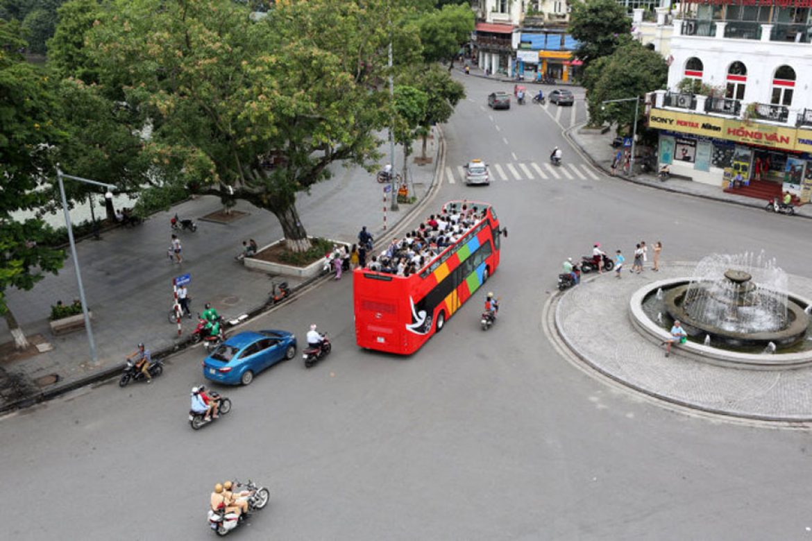 Two-floor buses run on the streets of Hanoi.