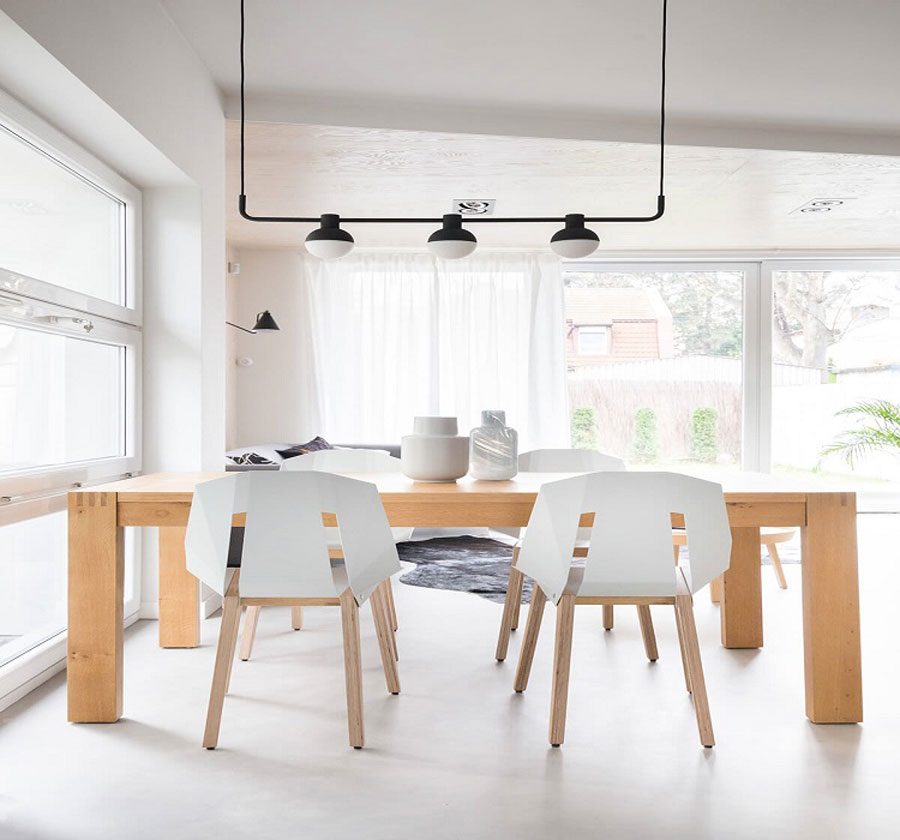 The dining table is designed with raw materials and carpentry, but still shows the modern